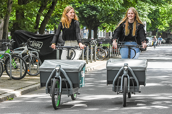 Zwei Frauen fahren mit einem Lastenrad durch Hannovers Südstadt.